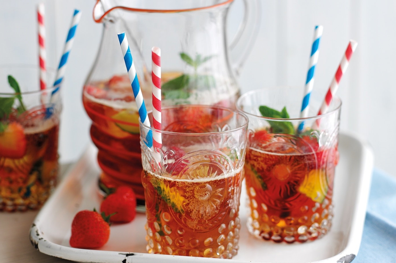 Pimms in glass cups with red and blue straws